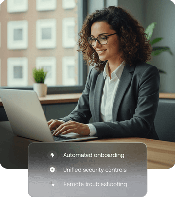 A professional woman working on a Mac laptop in an office setting, representing macOS device management and productivity.