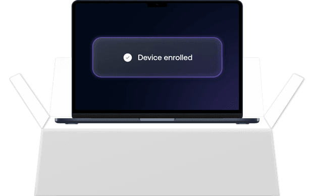 A Mac laptop screen showing a glowing “Device enrolled” confirmation banner, indicating successful macOS enrollment.
